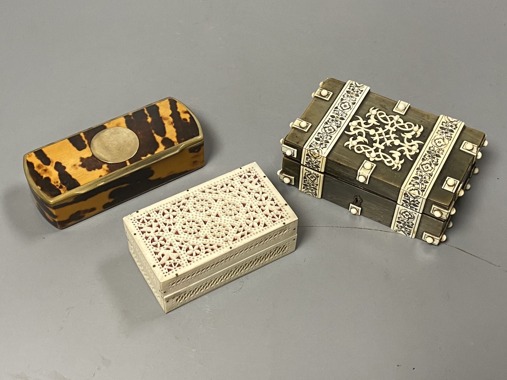 Three boxes including a horn veneered box, a tortoiseshell and bone